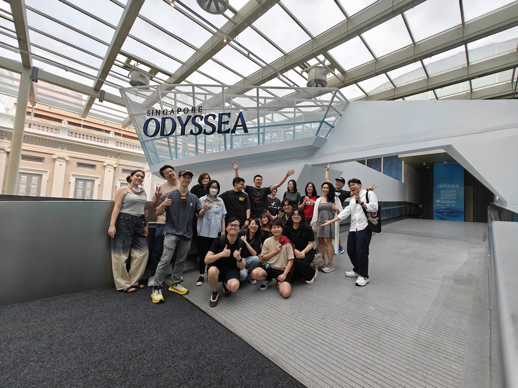 The CraveFX production team celebrating at the Singapore Odyssea venue entrance after completion.